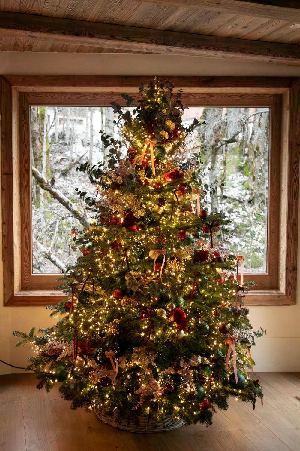 Christmas tree by the snow-framed window